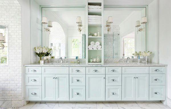 bathroom with light green cabinets and middle shelf divider