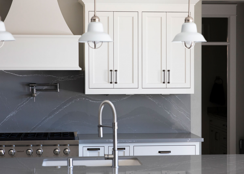 shaker style cabinet doors with a gray marble backsplash