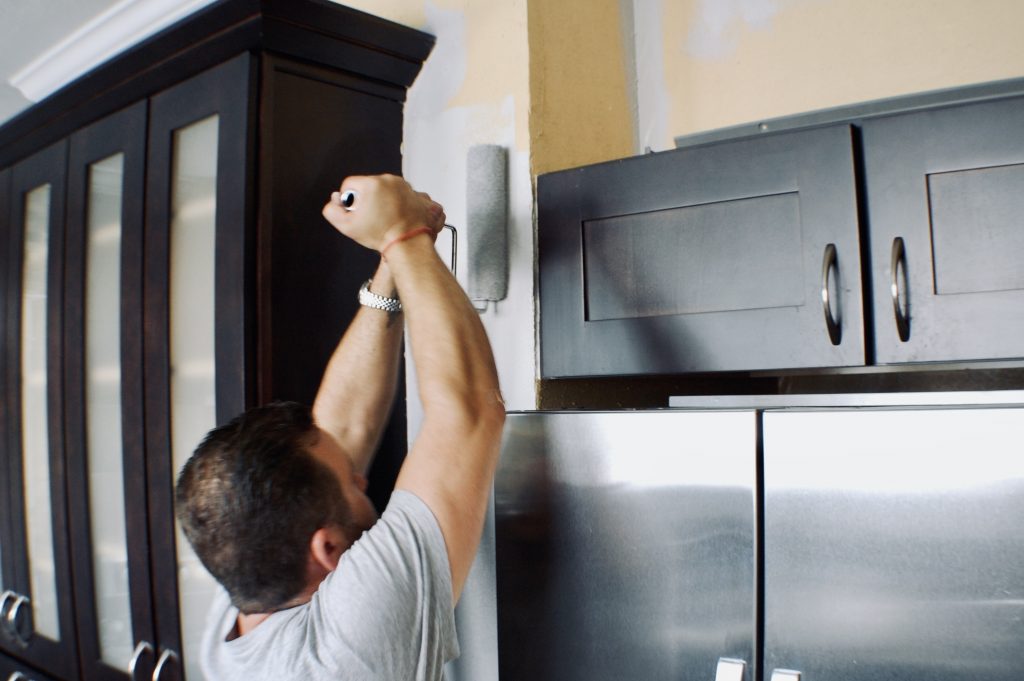 refreshing paint in a kitchen, going around black cabinets