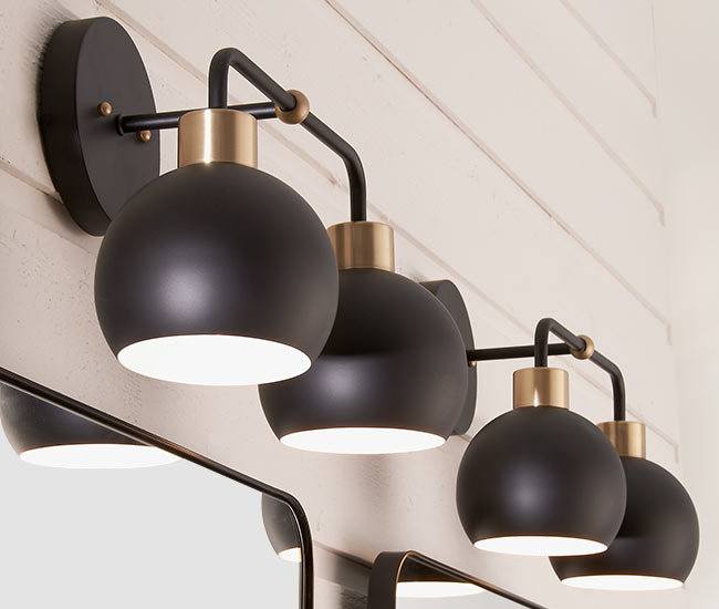 rounded matte black sconces over bathroom sinks and mirrors