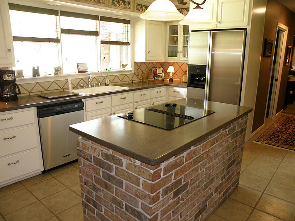 brick kitchen island with steel appliances