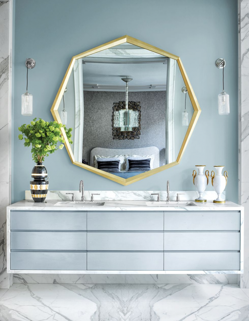 large geometric mirror above bathroom cabinets and sinks