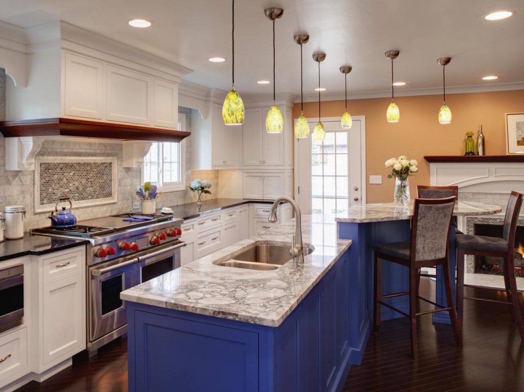 blue cabinets on a multi-level kitchen island 