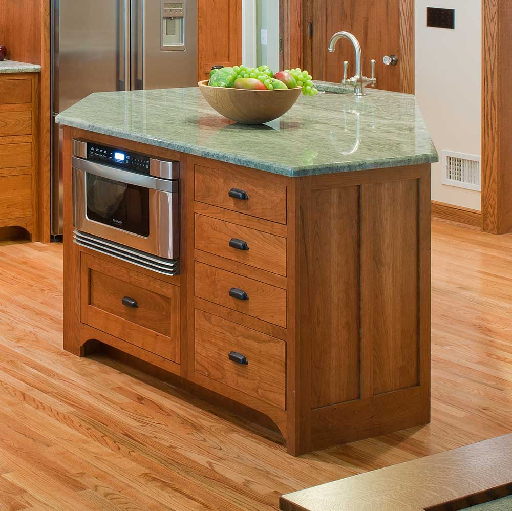 wood cabinets with green counter and built-in appliances