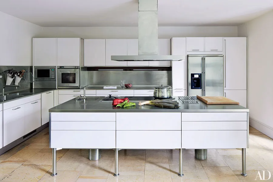 white and gray kitchen cabinets with stainless steel legs, industrial style kitchen