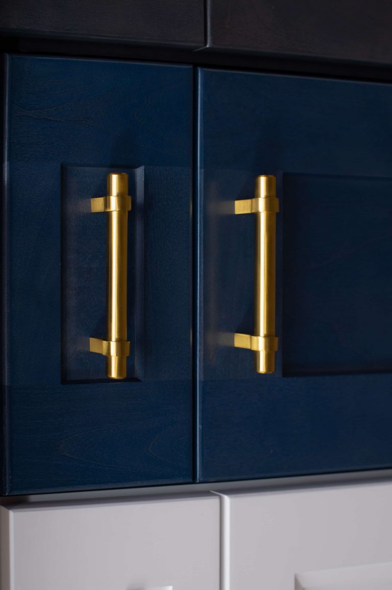 blue cabinet doors with gold bar handles