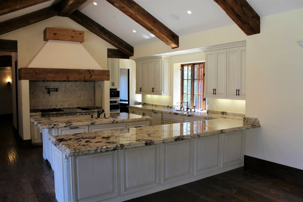 Country Style kitchen, muted, warm-tones neutral hues, dark wood furniture. 

Source: Oakridge Cabinets