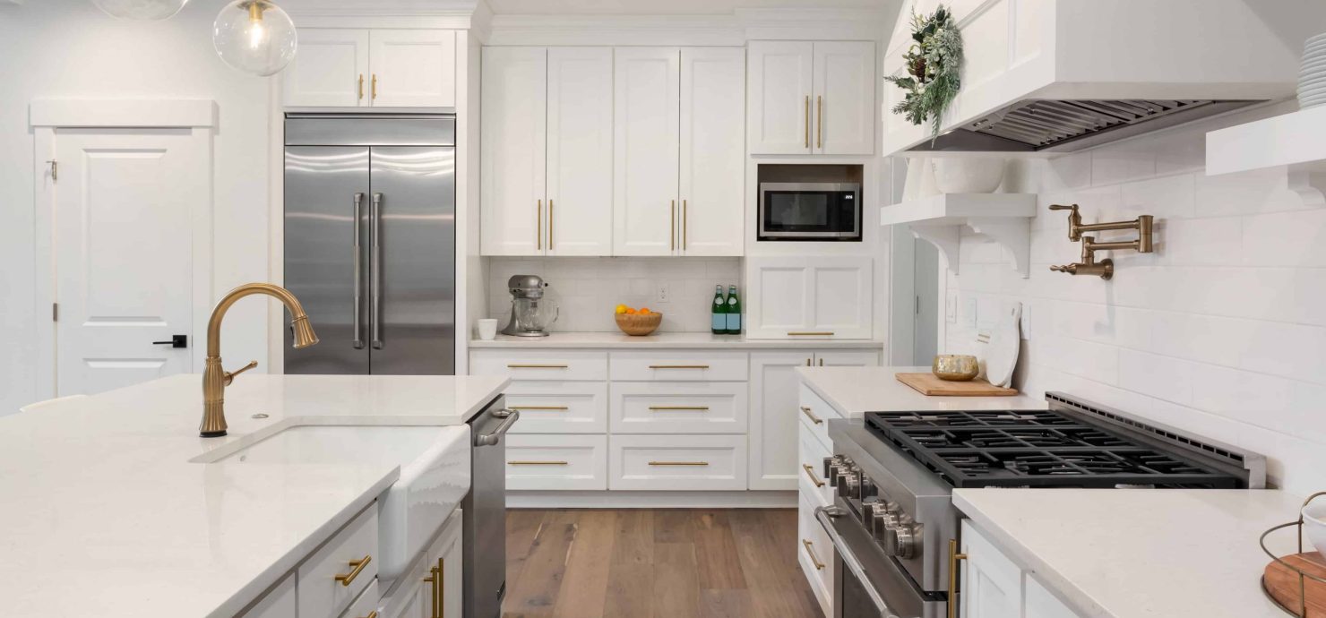 white kitchen and cabinets with gold handles