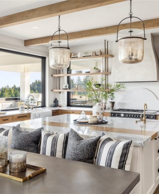 Traditional kitchen in new luxury home with hardwood floors, wood beams, large island and quartz counters