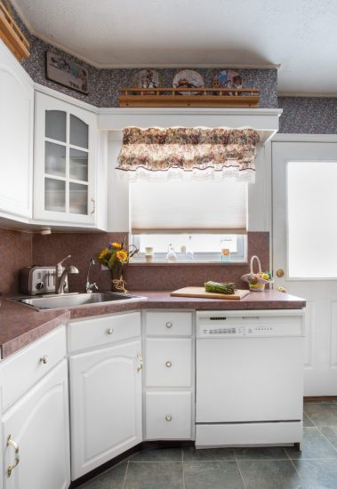 Clean white kitchen with asparagus on cutting board