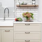 Kitchen interior near the wash basin with white cabinets in a minimal style.