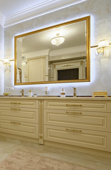 Modern luxury beige and golden bathroom with mirror, toilet, bidet and bathtub