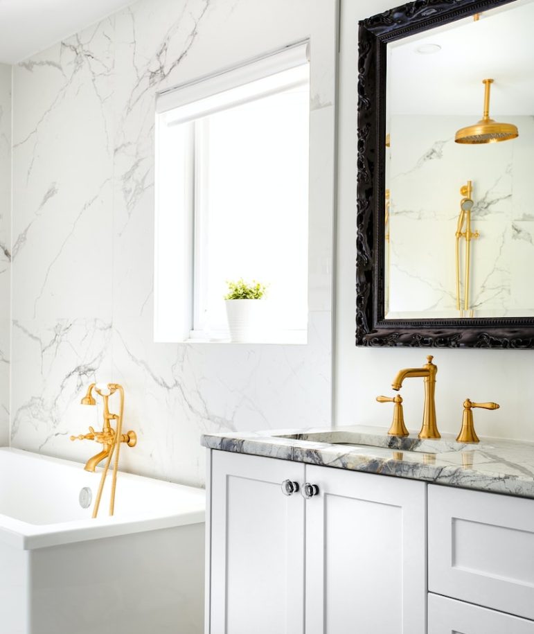 white ceramic bathtub with faucet