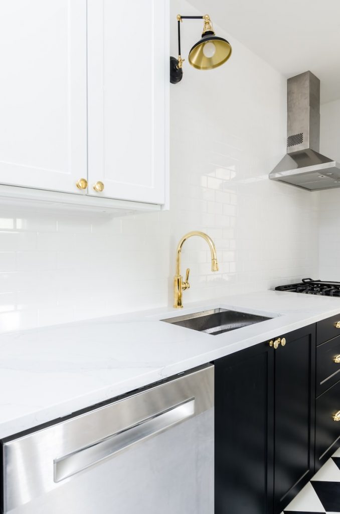 bright and white kitchen with black lower cabinets and shaker style doors, used to demonstrate what ikea replacement doors may look like