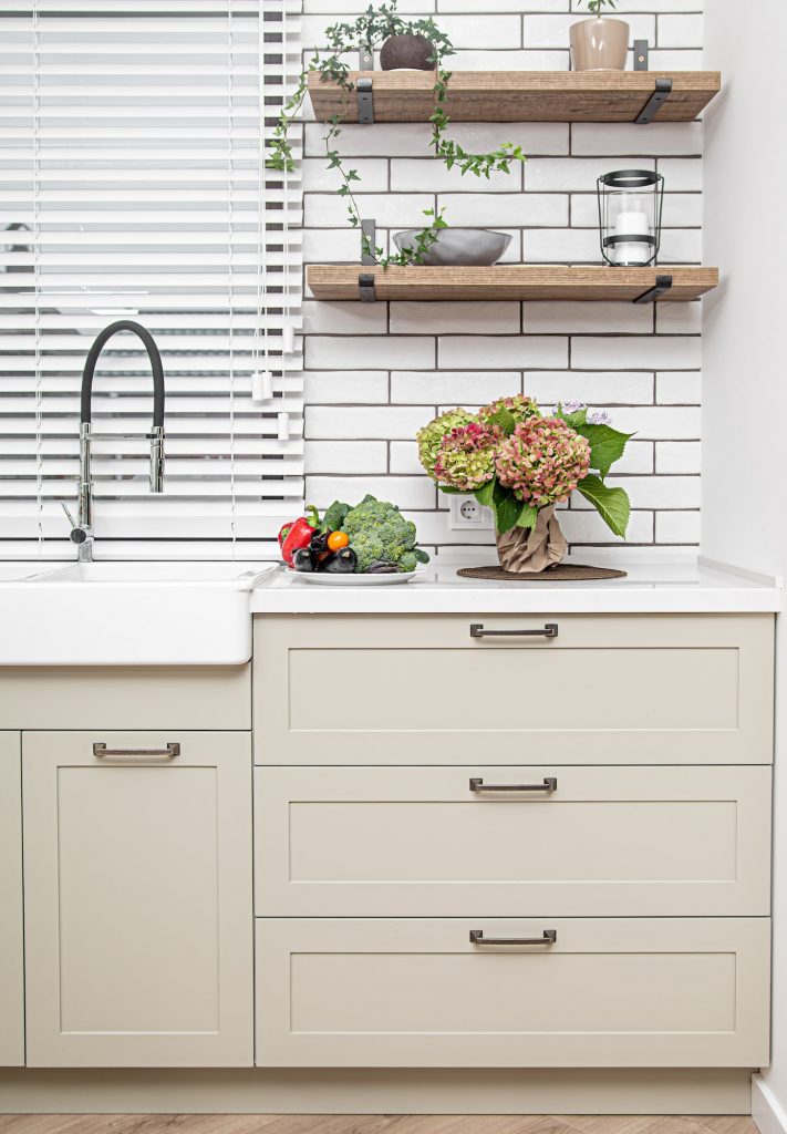 Kitchen interior near the wash basin with white cabinets in a minimal style.