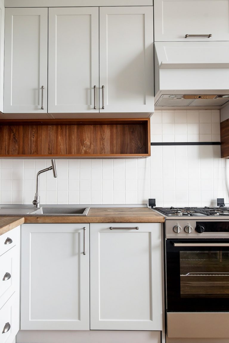 Light gray kitchen interior with modern cabinets and stainless steel appliances