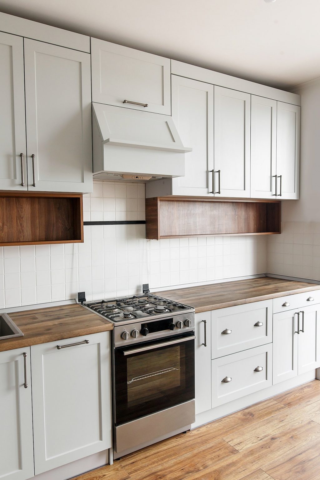 Light gray kitchen interior with modern cabinets and stainless steel appliances