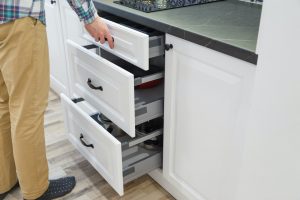 Men opensing white kitchen drawers