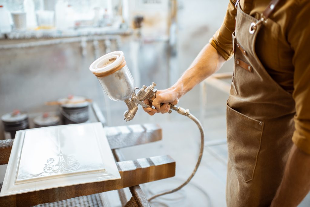 using a spray gun for cabinet paint eliminates paint streaks