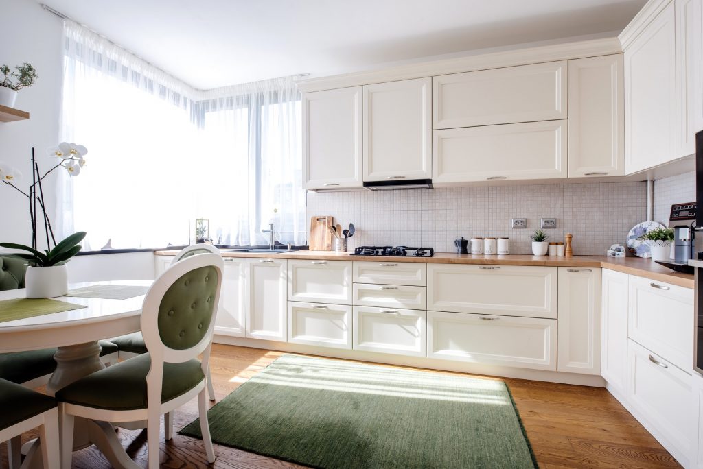 White cabinets in kitchen with a contrast of light wood counter