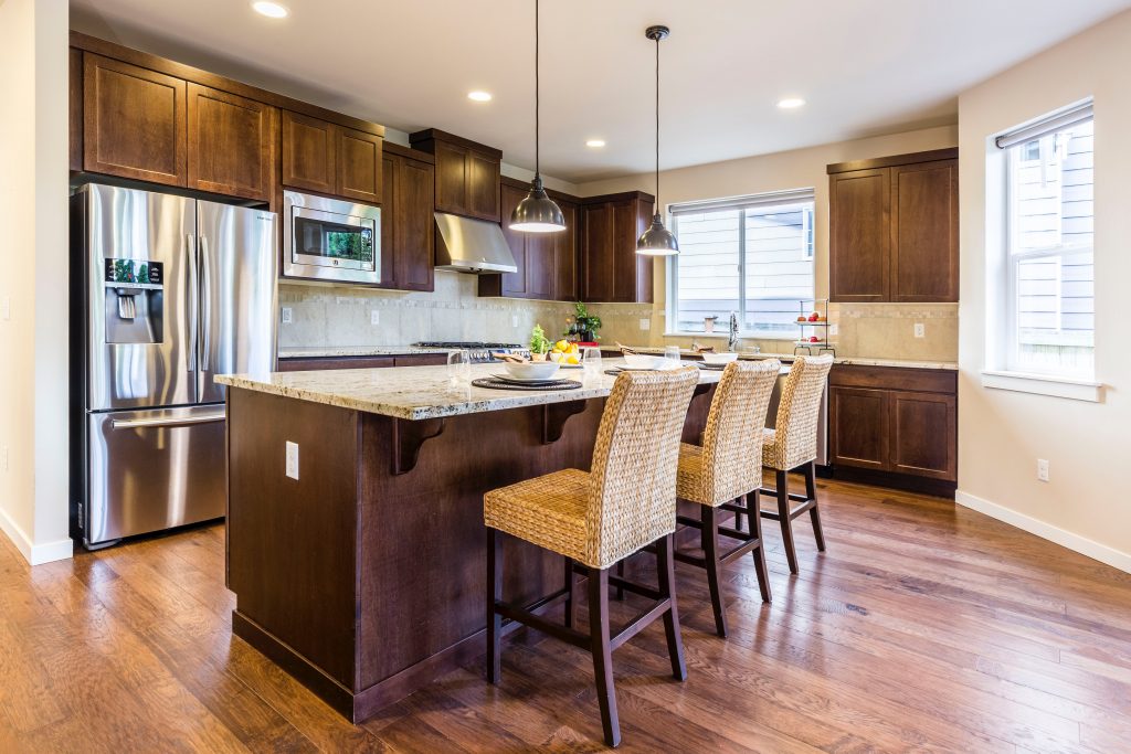 brown kitchen cabinet with contrast of light counter